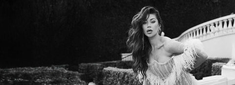 Woman with long, voluminous hair extensions in glamorous dress outdoors, Prolonged Hair brand