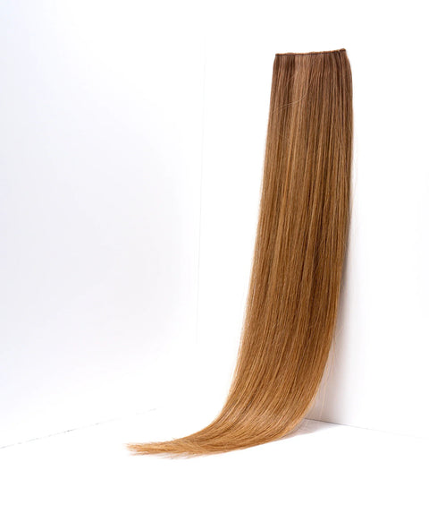 Prolonged Hair honey blonde straight hair extension weft on white background