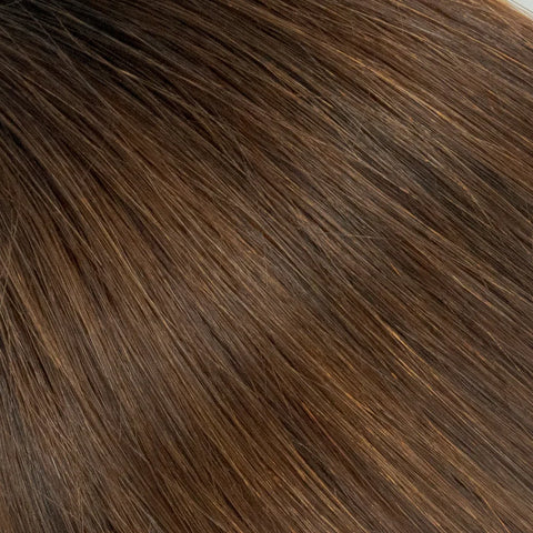 Close-up of natural brown raw hair extensions, smooth texture from Prolonged Hair